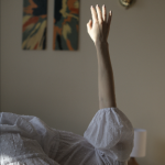 arm reaches up into the air and catches the light