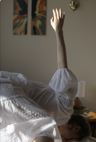 arm reaches up into the air and catches the light