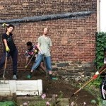Image representing four dancers, on the pile of dirt in the community garden, facing front, having garden tools in their hands 