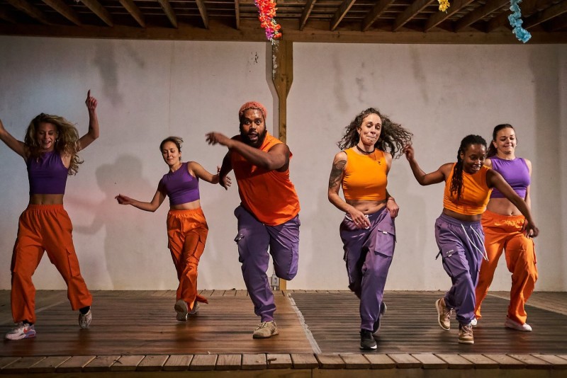 Dancers Unlimited Company dancers in orange and purple clothing 