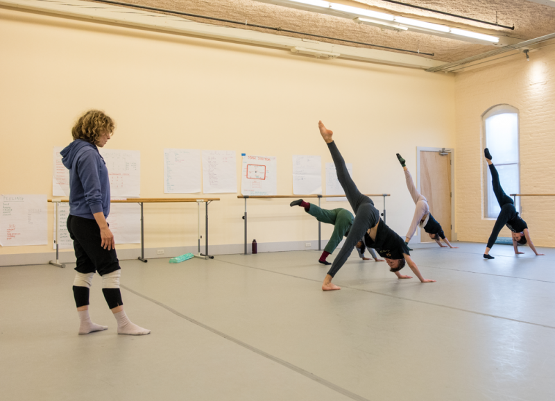 Teacher instructing dance class in a studio