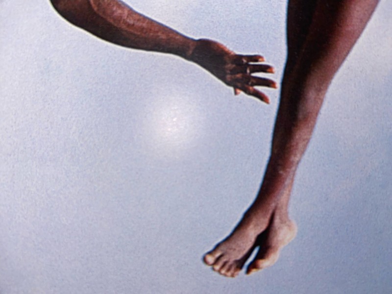 Image of two dark-skinned dancers against a sky-blue background