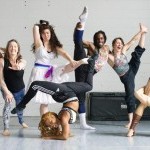 seven exuberant artists strike silly acrobatic poses in the circus studio 