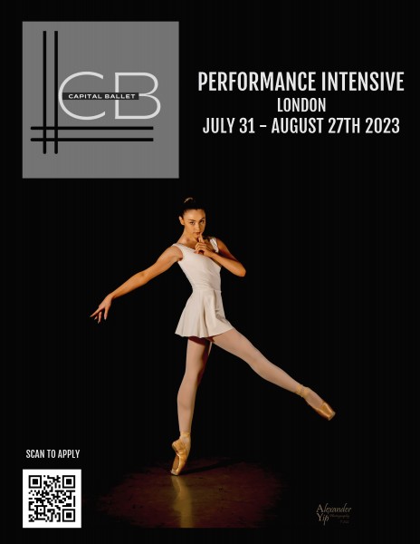 A ballerina in a simple white dress poses on point