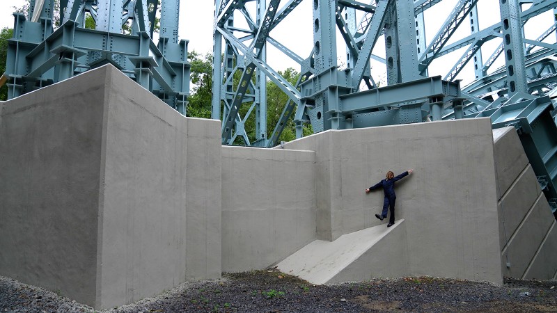 a dancer explores the architecture of a bridge in new york city