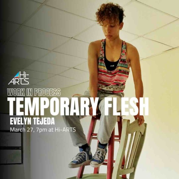 a photo of Evelyn sitting on top of a tall stack of chairs.