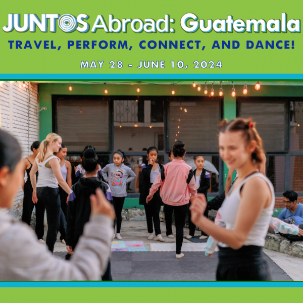 A dancer interacts with a student on an outdoor stage in Oaxaca, Mexico.