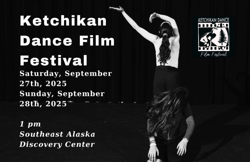 Black & white photo, one dancer stands with her back towards camera arms swaying to left, a second dancer sits in front