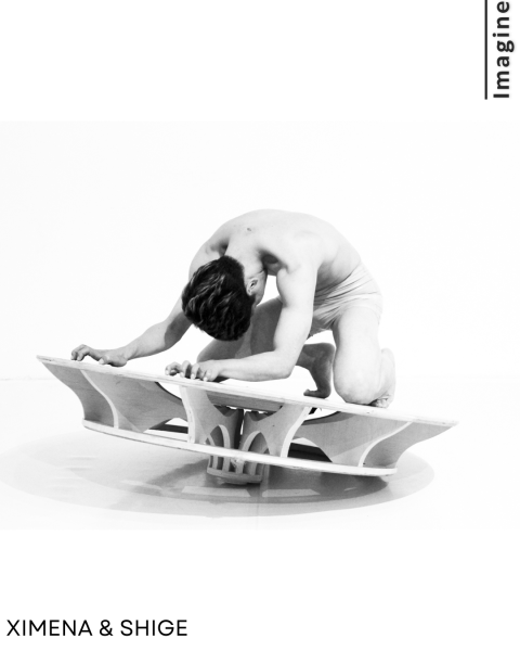 A dancer layed down in a wood sculpture