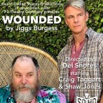 Two men, one seated in a flowery robe, the other standing and stoic