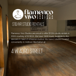 A wood floor studio with mirrors is dimly lit by natural light peaking in through windows adjacent the mirror.