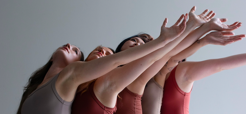 5 dancers reaching their left arm to the upper diagonal