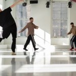 three dancers moving through a white studio space with lost of natural light