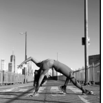 woman arches backwards in yoga pose on a bridge