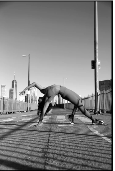 woman arches backwards in yoga pose on a bridge