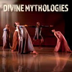 a group of dancers in lavender and sand-colored, floor length dresses arch and look upward