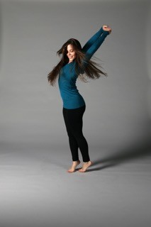 A dancer in blue and black twirls around.