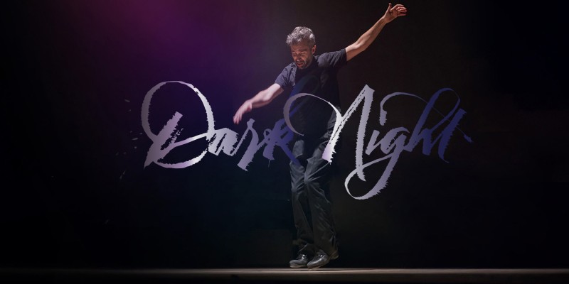 Image of Andrew Nemr dancing with calligraphy text of "Dark Night" in front of the image