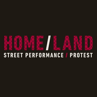 Black silhouettes march as one carries a red picket sign.