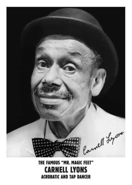 Black and white headshot of a man wearing a white shirt, polka dotted bow tie, and black hat with his signature in black.