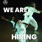 A photo of two dancers in motion wearing all white. Text on the screen says “We are hiring” along with the Company Logo