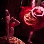 Two dancers in yellow and red hoop skirts