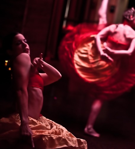Two dancers in yellow and red hoop skirts