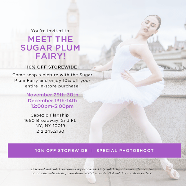 A ballerina in a white tutu and leotard posing in front of a cityscape.