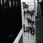 A subway platform colum with the graffiti written words: "Do What You Love"