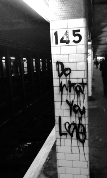 A subway platform colum with the graffiti written words: "Do What You Love"