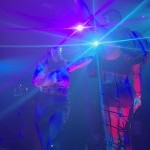 Two jazz dancers onstage in a disco ballroom
