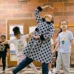 Girl dancing with joy balancing on one leg!