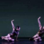 two dancers holding a strong shape