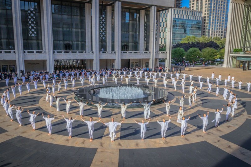 Three circles of Dancers in white on beige/gray granite outdoor plaza