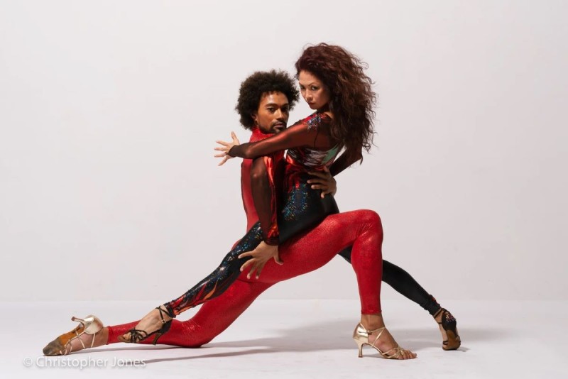 Partner Duet, Dancers w/ black hair, in red, black, gold costumes and heels