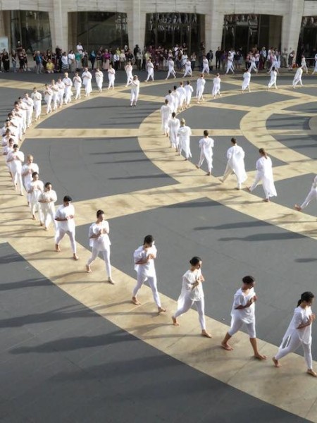 Over 180 dancers dressed in white form concentric circles on the Josie Robertson Plaza 