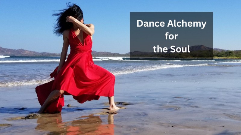 Dancer with dark hair and wearing a red dress dancing on beach