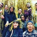 group of 9 interns in a cloud of gold fringe