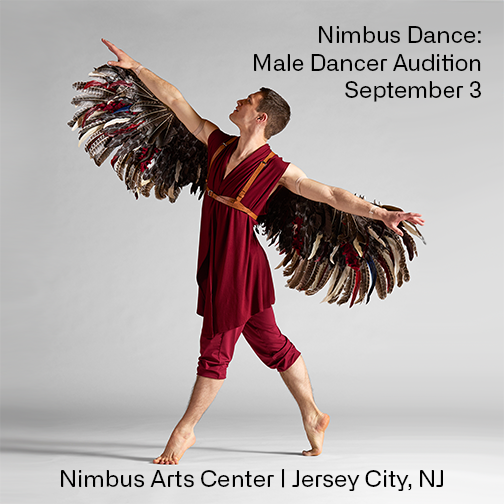 A male dancer in flowing red costume and elaborate feather wings reaches both arms and stands in 4th position releve