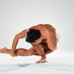 Dancer bending forward touching foot