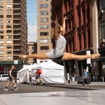 A dancer leaps with the city as a backdrop behind her