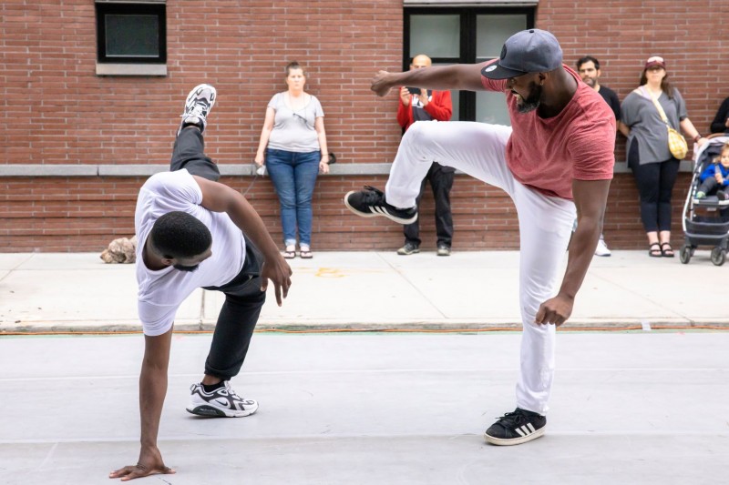 Two hip hop dancers perform on the street
