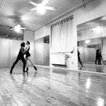 in the studio, 2 dancers partnering facing each other