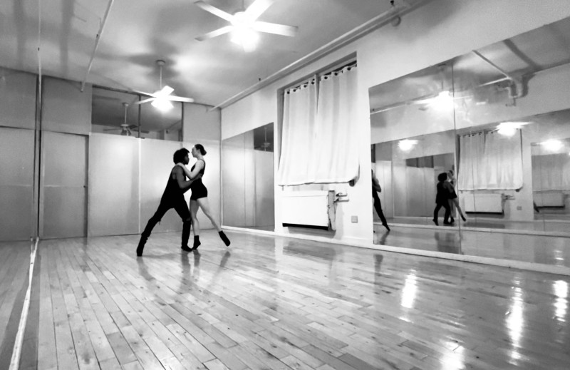 in the studio, 2 dancers partnering facing each other