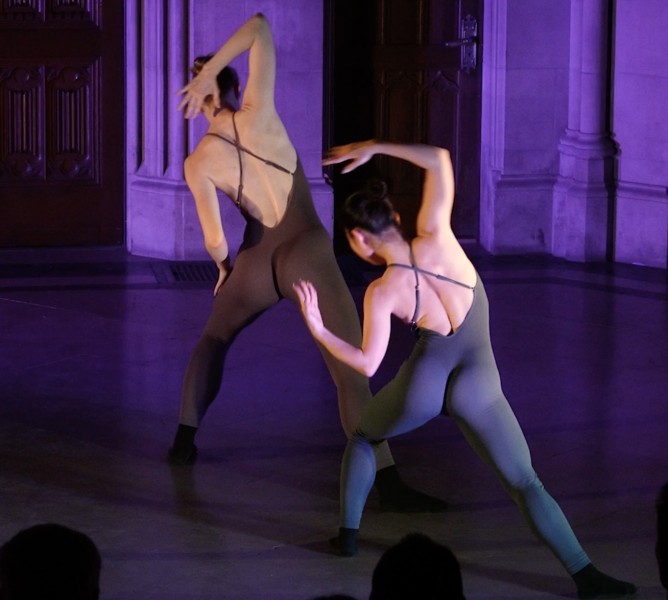 Two dancers back to the audience