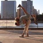 Male dancer lifting female dancer on his back, female dancer facing sky