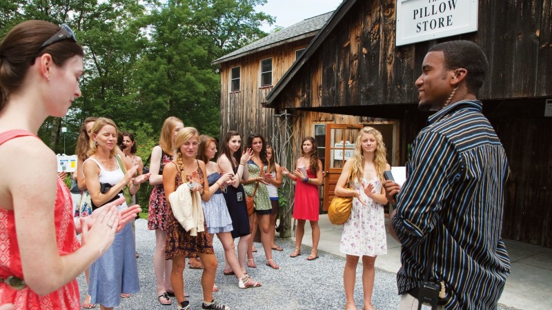 Smiling Festival intern speaking to a group of campus visitors.
