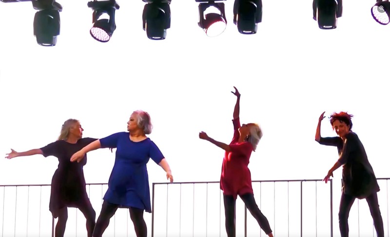 Senior dancers in varied colors and individual poses, performing outdoors  in front of a white background 
