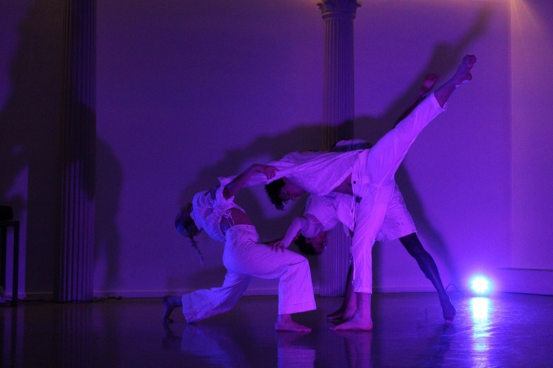 Three Dancers Pose in Dark Purple Lighting