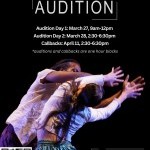 Two dancers face and mirror each other with arms extended and reaching to the right 